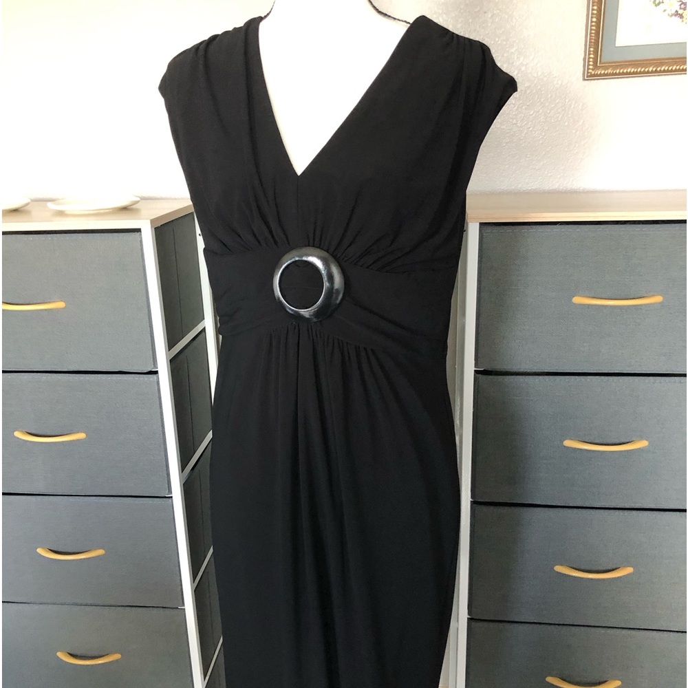 This is an elegant black dress used only one time and has been dry cleaned.